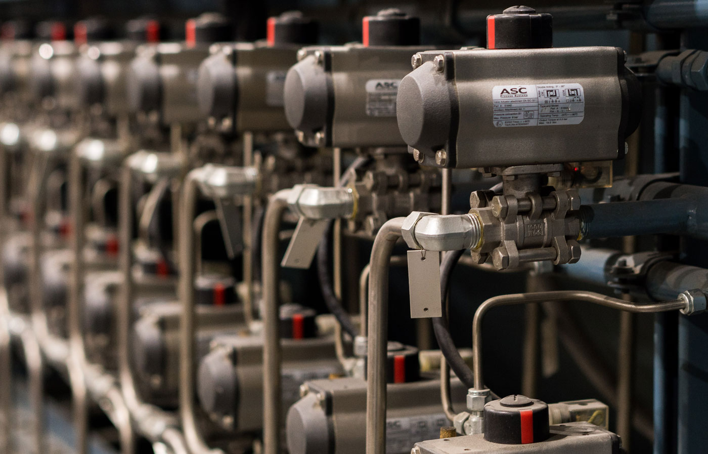 Row of precision machined actuator assemblies on Hydrojet's production floor